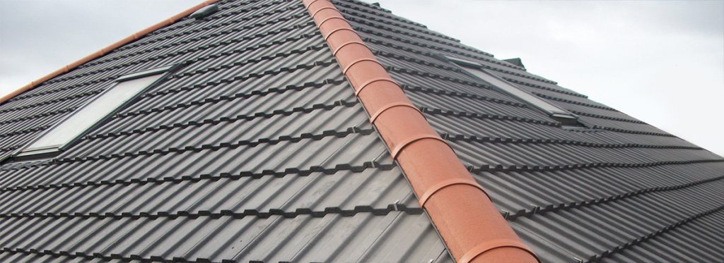 Concrete tiled roof with a terracotta ridge